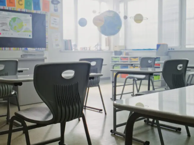 Interior of an empty primary school classroom.